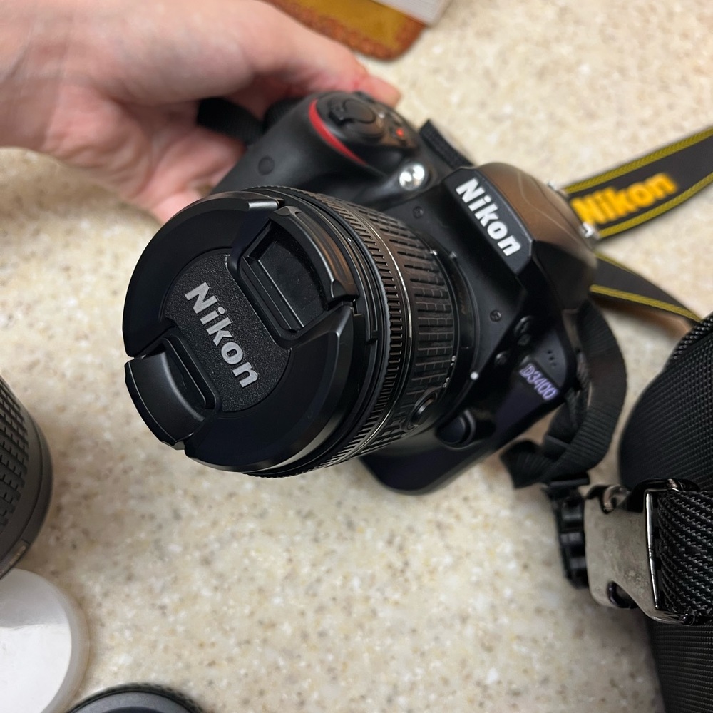 Nikon D3400 DSLR Camera with two lenses, 2 batteries, battery charger, and bag